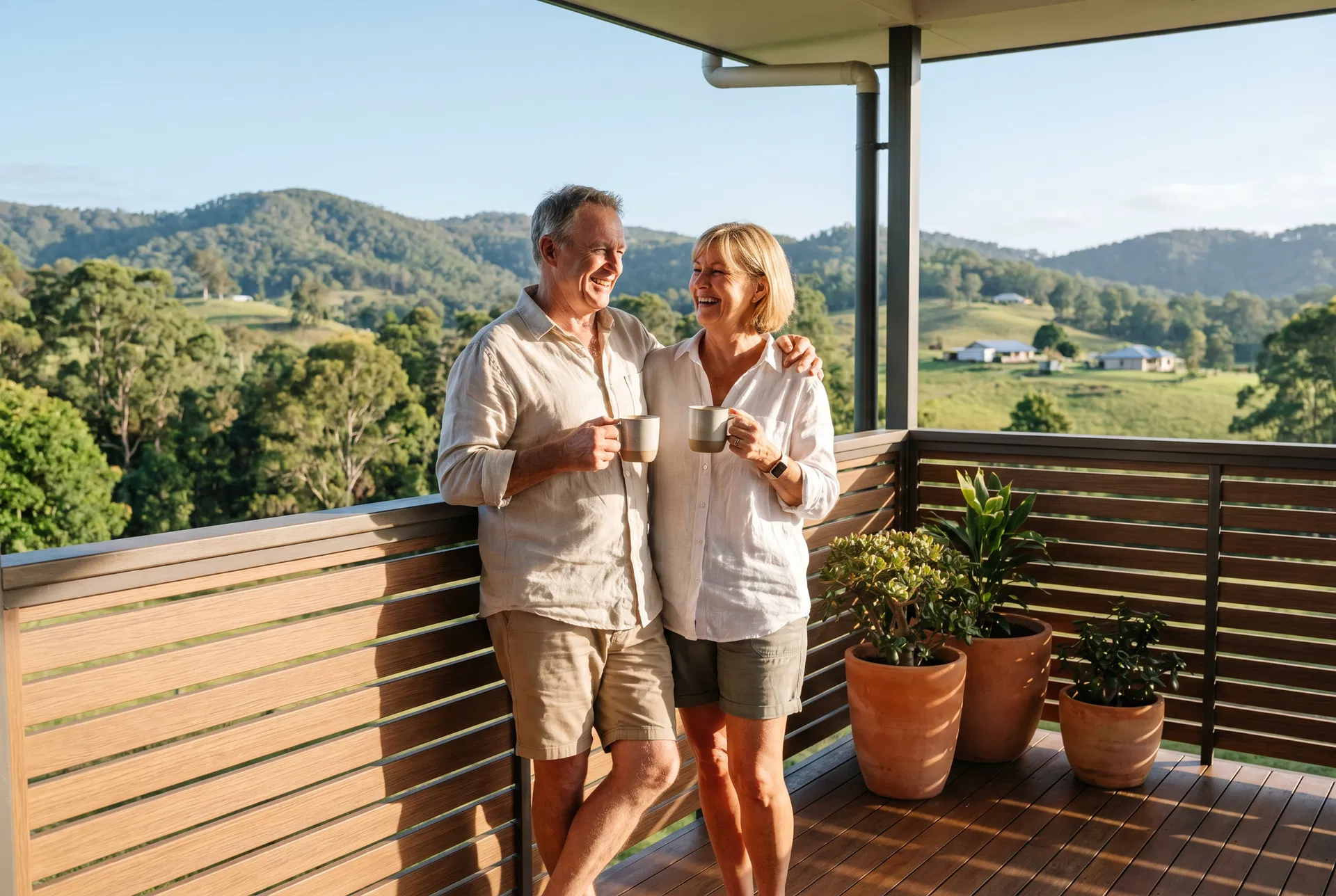 Mature couple enjoying coffee on a modern balcony